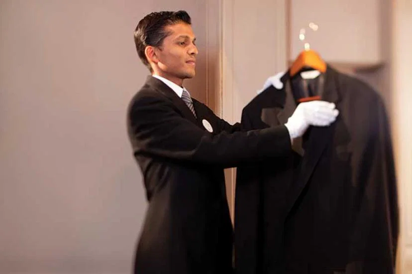 Butler combing a jacket