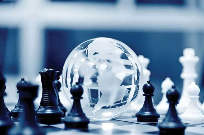 Globe and chess pieces strategy theme iStock-485959046