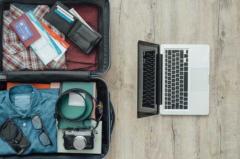 Laptop packing suitcase iStock-599981132
