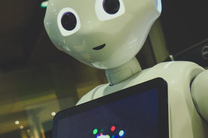 AI Robot holding tablet_Photo by Owen Beard on Unsplash.png