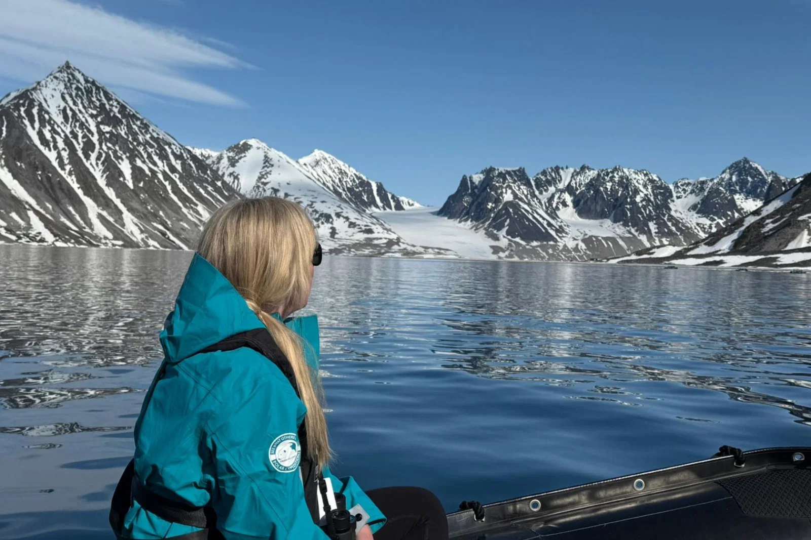 Rebecca Barnes rides on a Zodiac in Svalbard