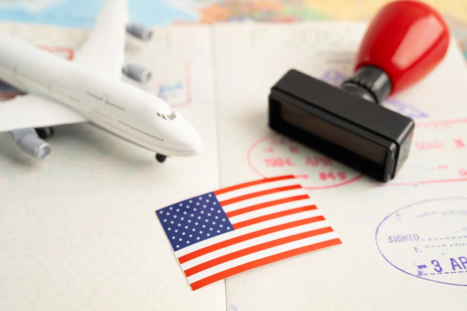 A mock up of an aircraft with a US flag and passport stamp