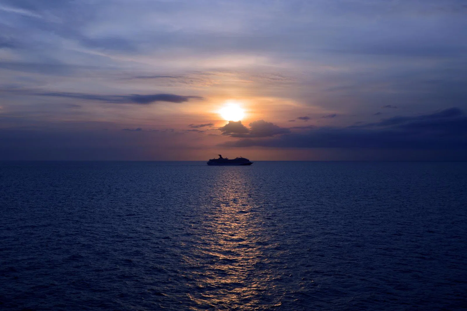A cruise ship pictured at sea at dusk
