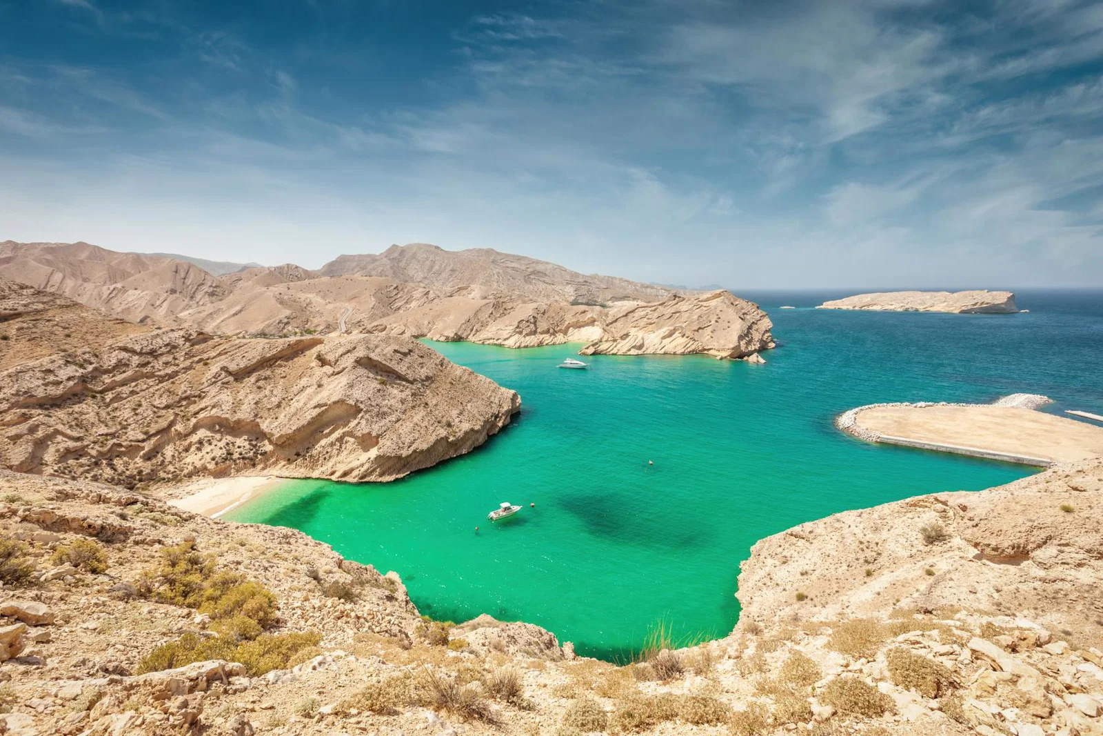 View of mountainous coastline surrounding a turquoise lagoon