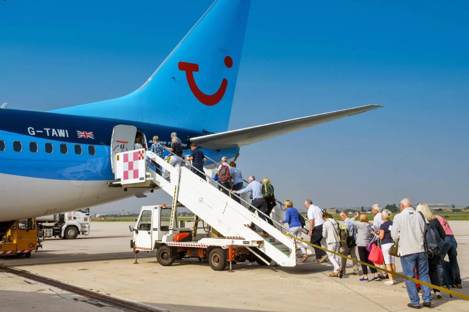 Passengers board a Tui aircraft