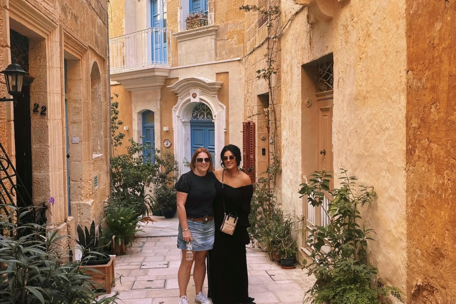 Cerys and colleague post in pretty street in Malta
