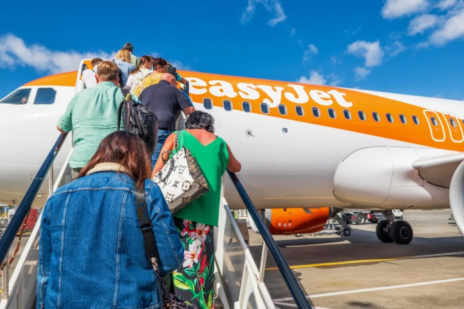 Passengers board an easyJet aircraft