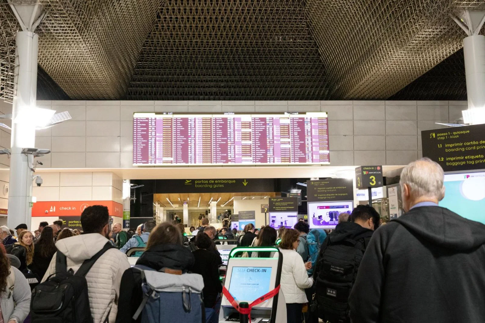 Travellers check in at Lisbon airport