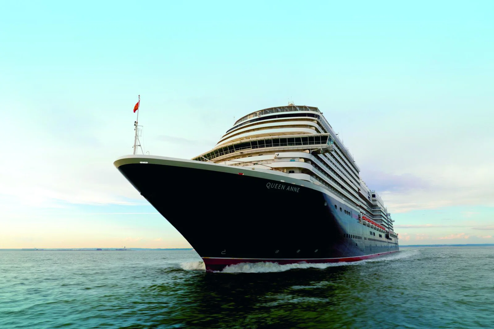 Luxury cruise ship sailing on bright day 