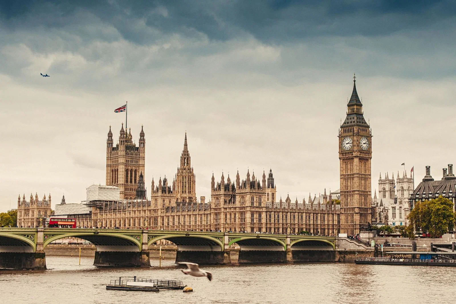 An aircraft flies over the UK parliament in London