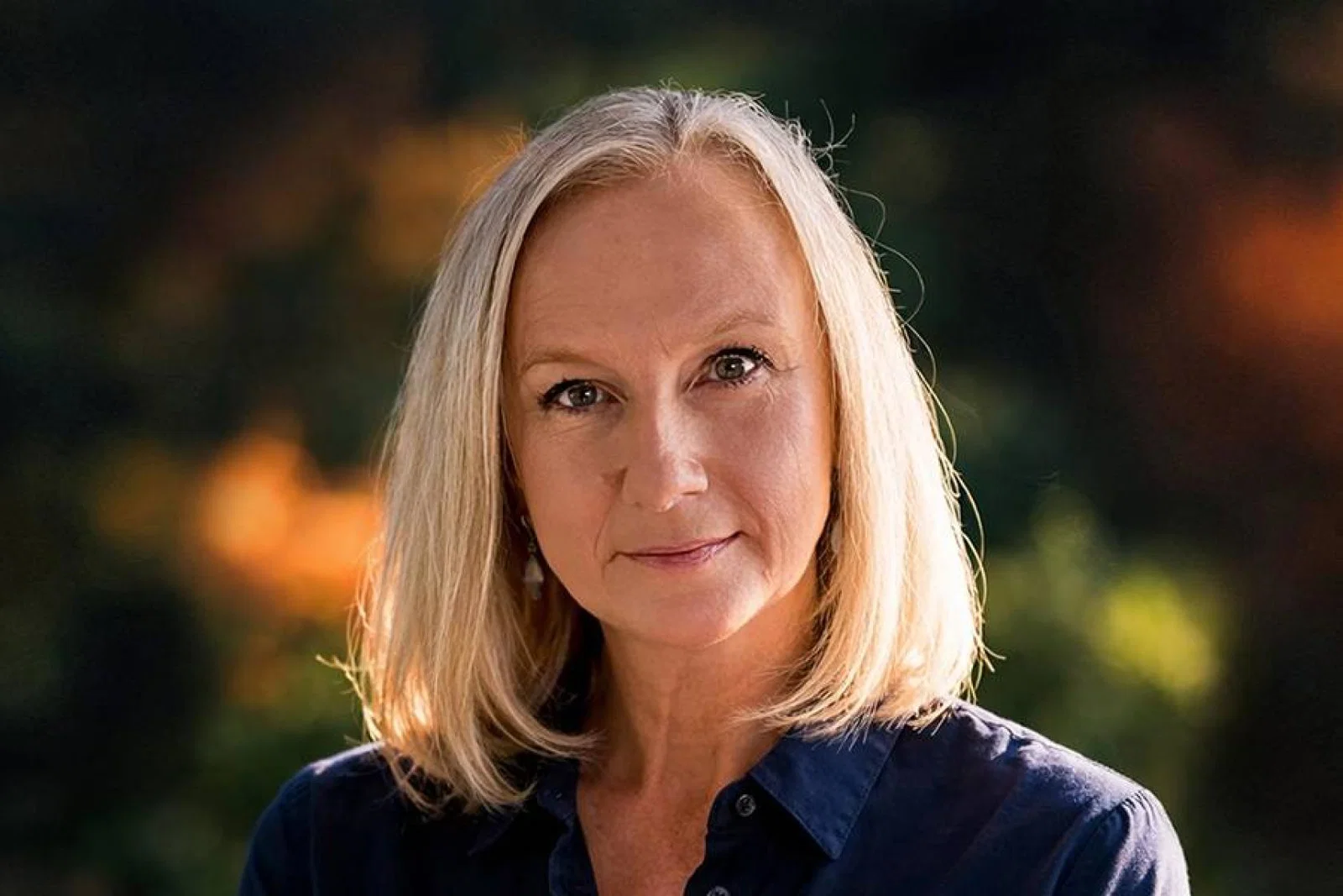 Blonde woman with navy shirt 