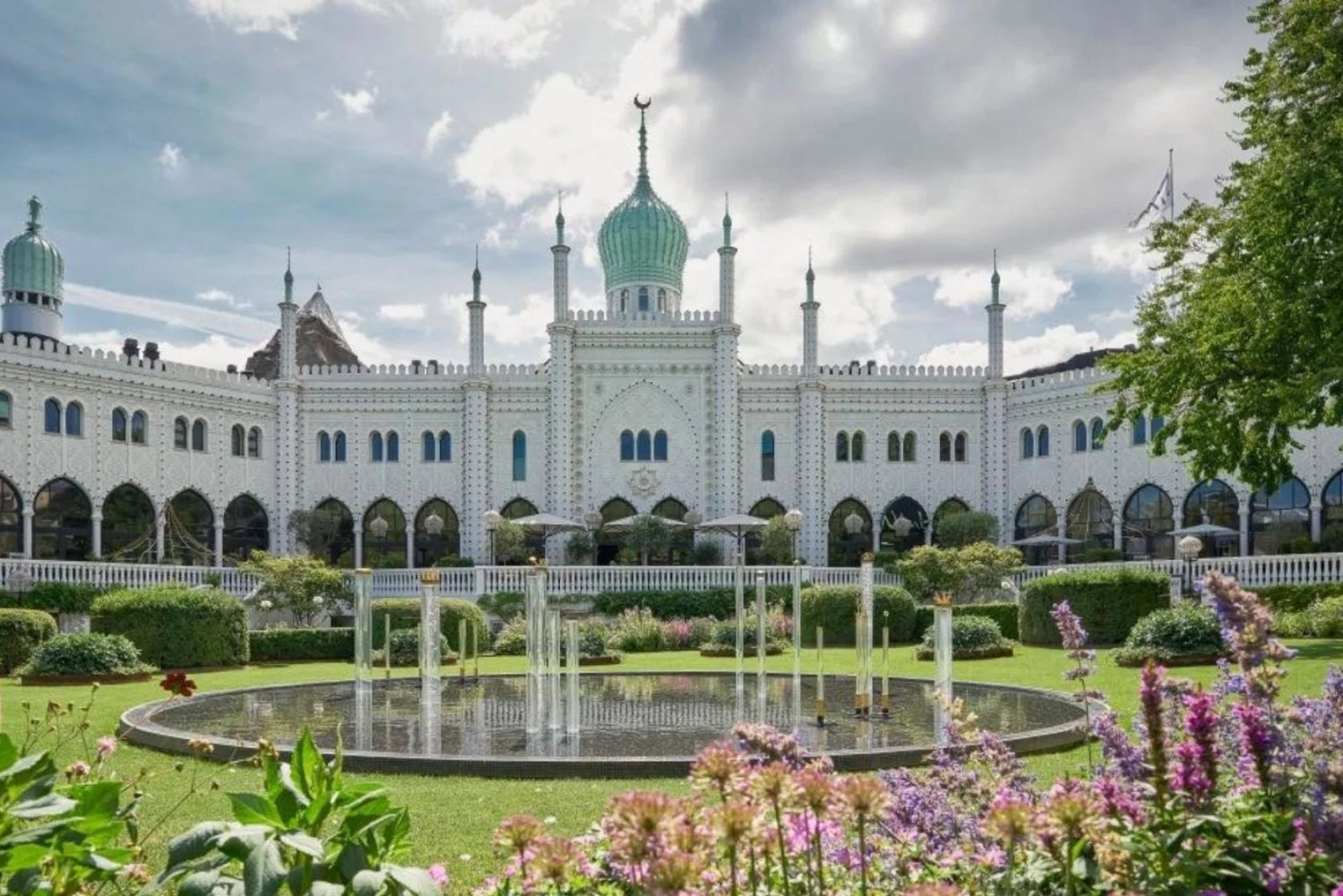 White palace-like hotel with green gardens 