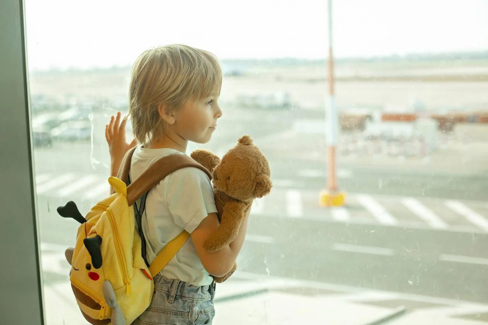 Child looking out of airport window