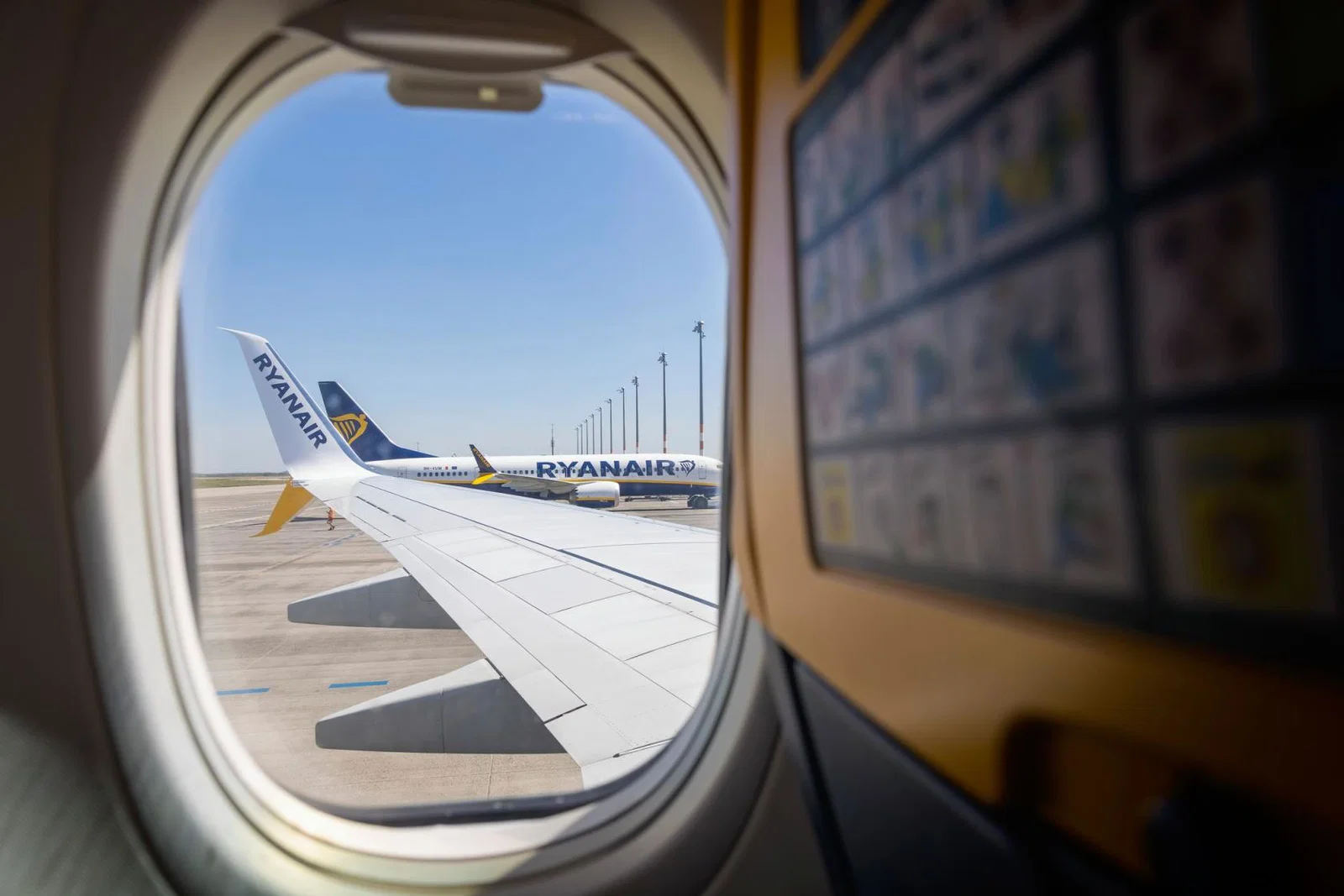 A Ryanair aircraft at the stand pictured through an aircraft window