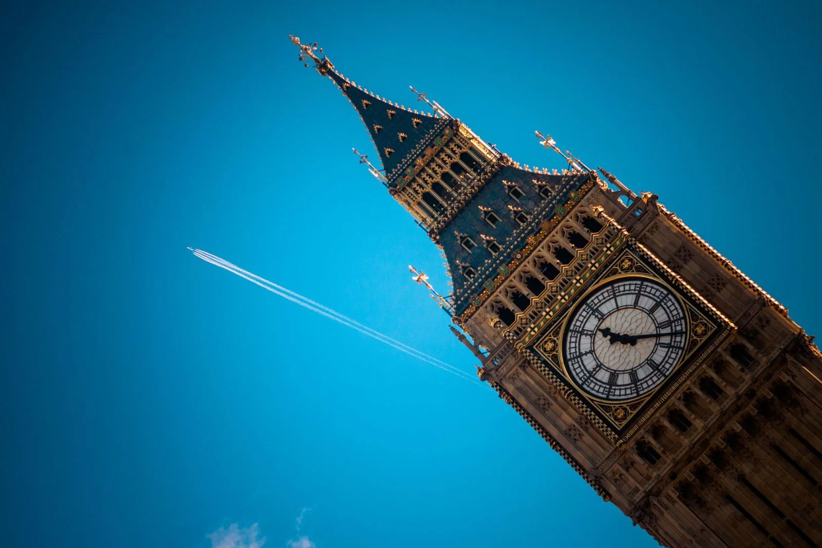 An aircraft flies past the Houses of Parliament in London