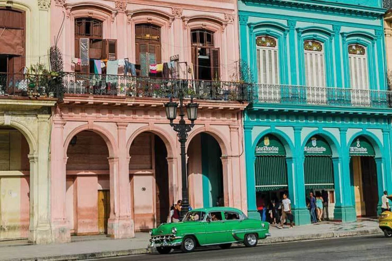1950s vintage car parked in front of buildings in Old Havana Cuba