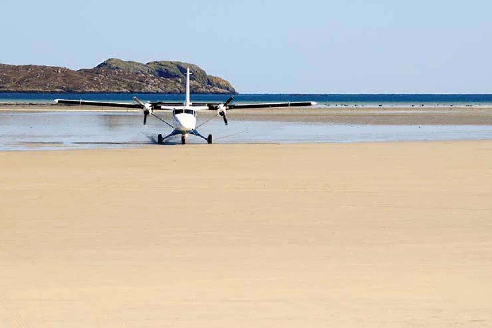 Light aircraft landing on beach iStock-174798675