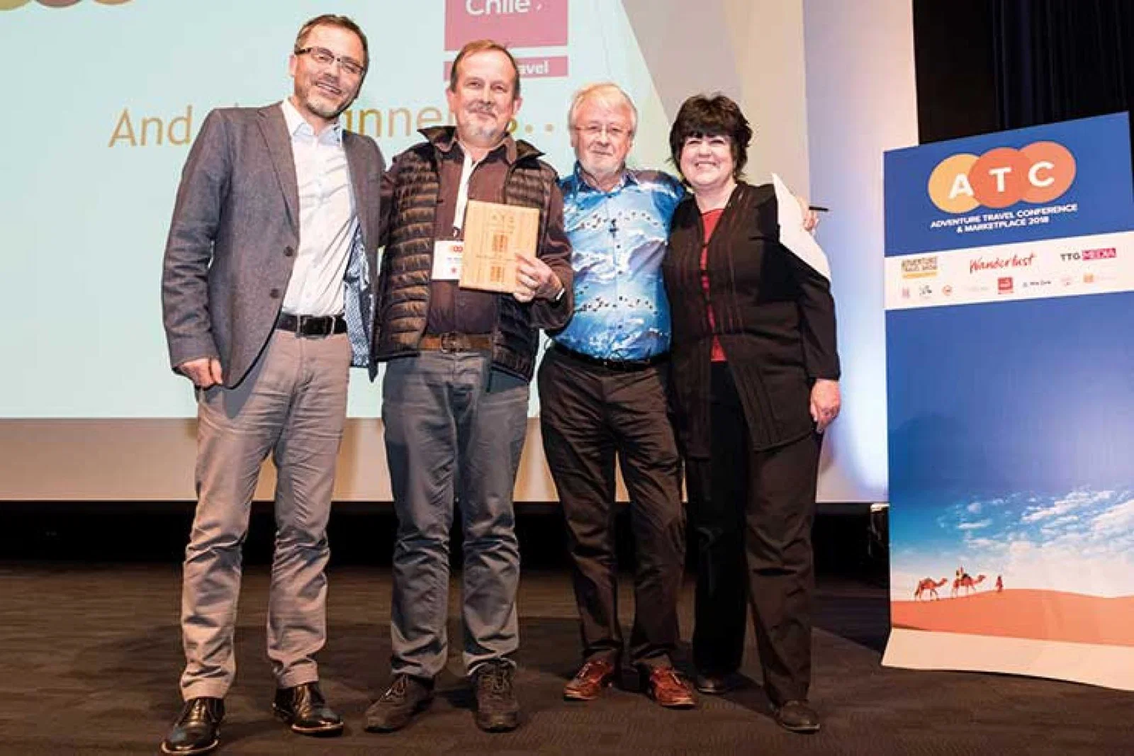 Pete Burrell winning the Contribution to Adventure Travel award at the Adventure Travel Conference i