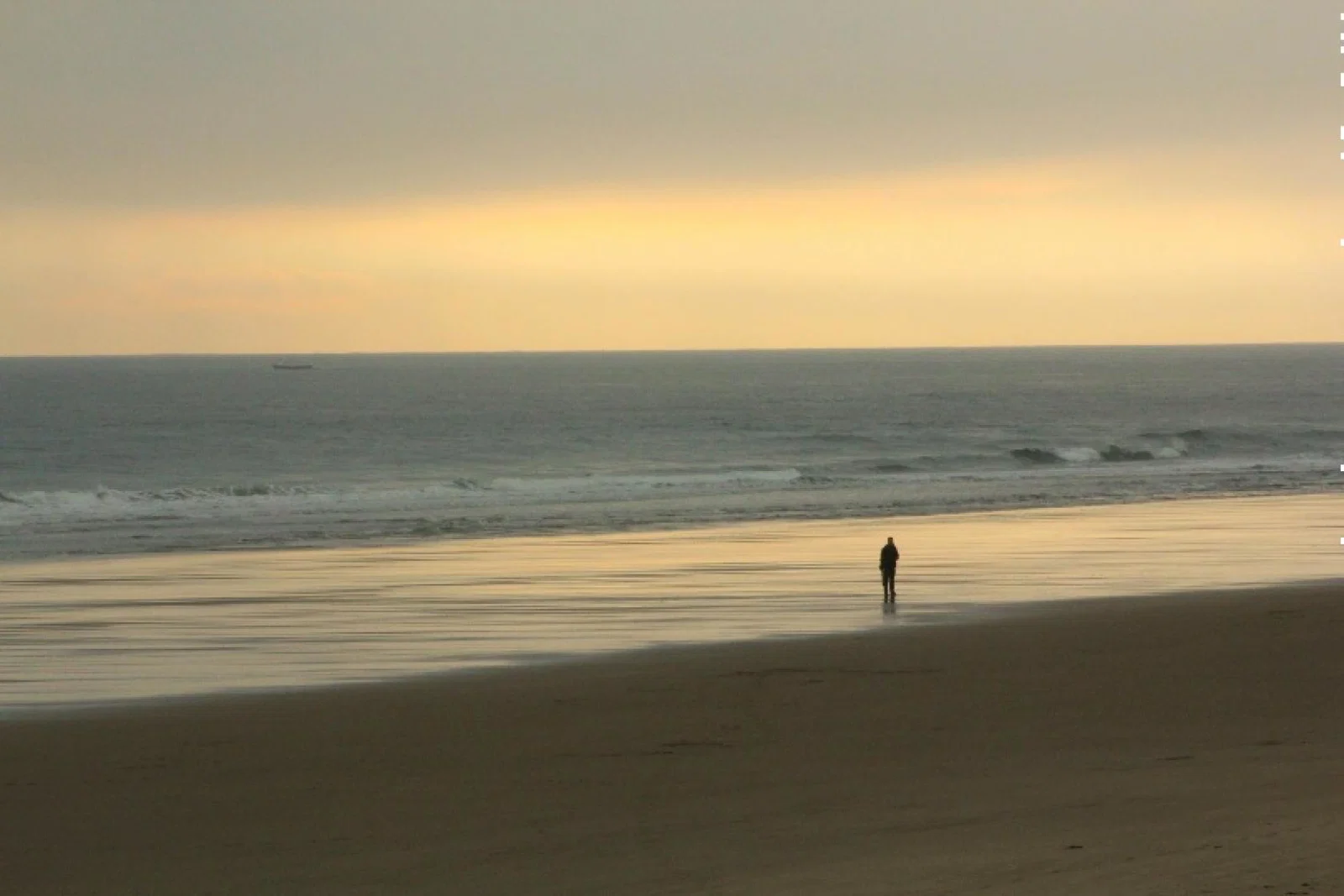 Demand for domestic breaks is soaring (Pictured: Bamburgh Castle Beach; Credit: Paul Levesley / Unsplash)