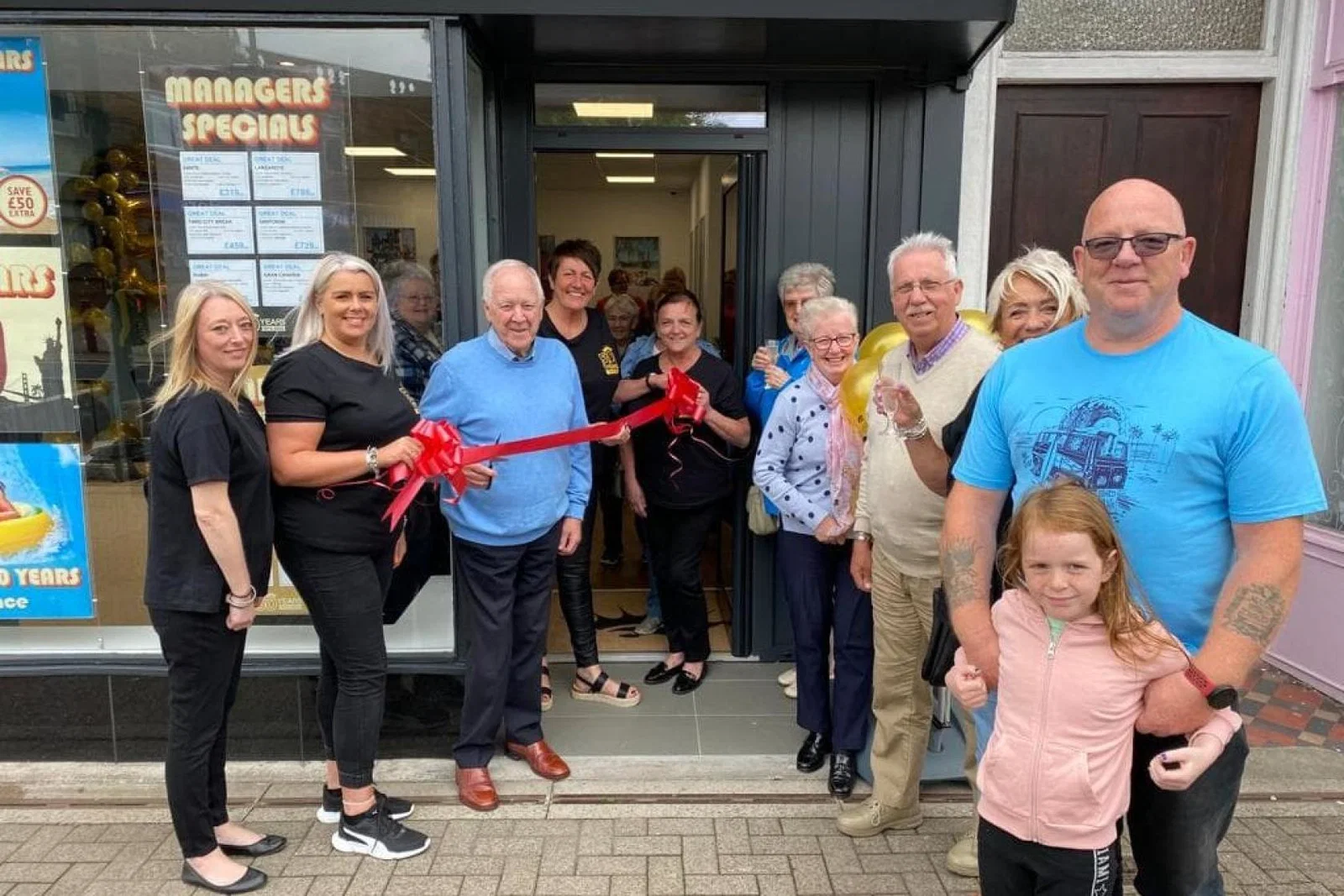 Former Scotland football manager Craig Brown cuts the ribbon at Stewart’s Prestwick store celebrations