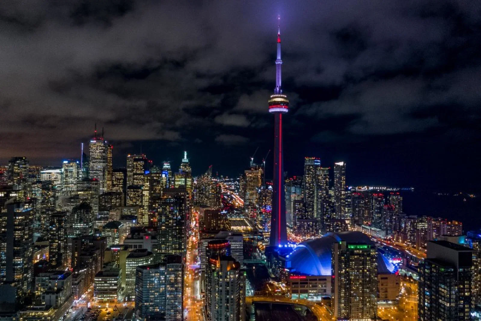 The CN Tower dominates the skyline night and day