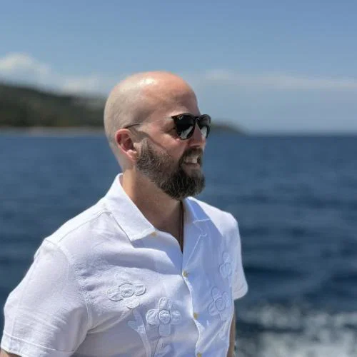 Man with sunglasses looking out to sea 