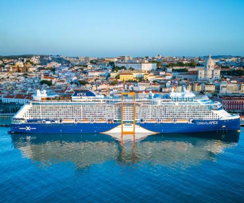 Celebrity Apex ship docked up with Lisbon city landscape in the backgroun