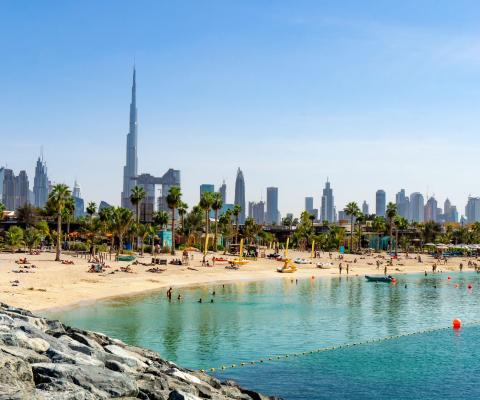 A beach in Dubai with the city pictured in the background