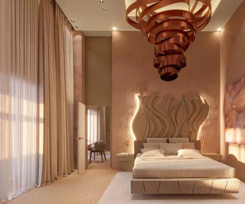 Luxury bedroom at Iniala Solis featuring a low platform bed, sculptural chandelier, warm ambient lighting, tall sheer curtains, and textured wall art in soft neutral tones. 