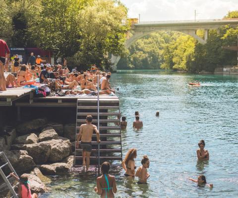 People enjoying a refreshing swim in Rhone River, Geneva