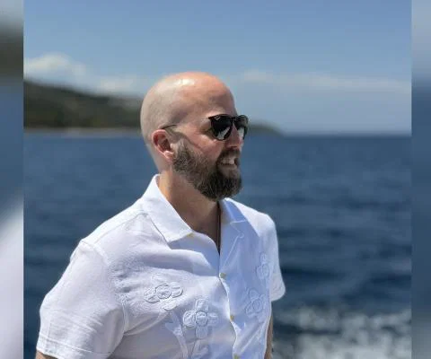 Man with sunglasses looking out to sea 