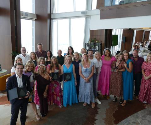 Group of people holding awards 