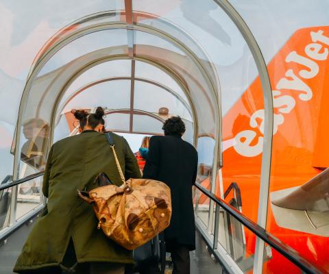 Passengers board an easyJet aircraft