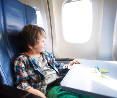 Boy on aircraft (stock)