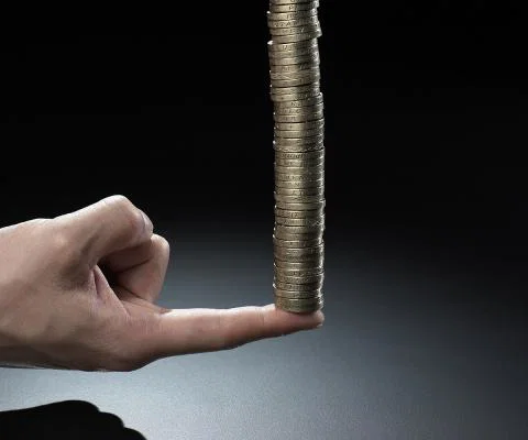 Growth concept - stack of coins on a finger (stock)