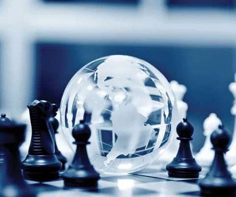 Globe and chess pieces strategy theme iStock-485959046