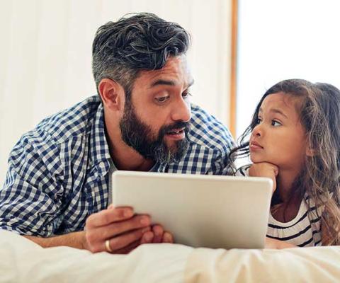 Father and child with tablet device