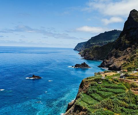 Madeira's beautiful coastline features verdant cliffs and azure waters (Credit: Stephen Lammens/Unsplash)