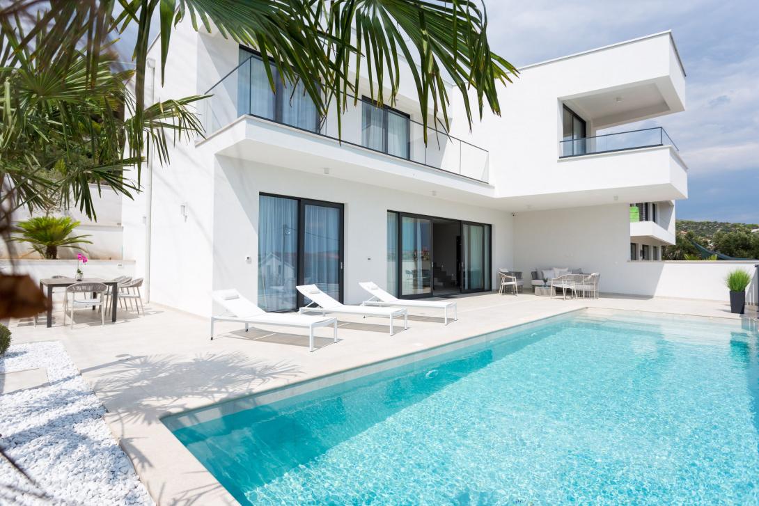 Clients can tailor their holiday to their needs with SPL Villas A white villa with a pool, available with SPL Villas