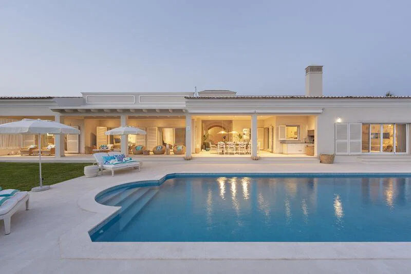 exterior of white, single-storey villa with pool