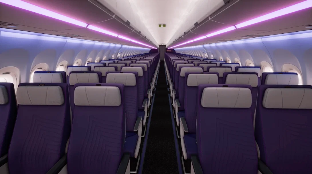 View of economy seating on Thai Airways flight with low purple lighting and aisle