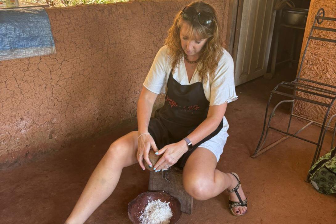 Caroline dehusking coconuts Caroline dehusking coconuts