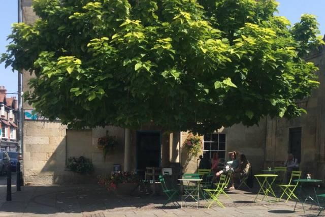 Pebbles Travel has has outdoor seating underneath its Indian bean tree Pebbles Travel has has outdoor seating underneath its Indian bean tree