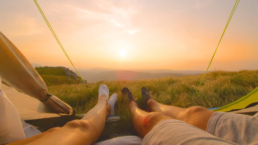 Two travellers enjoy a sunset