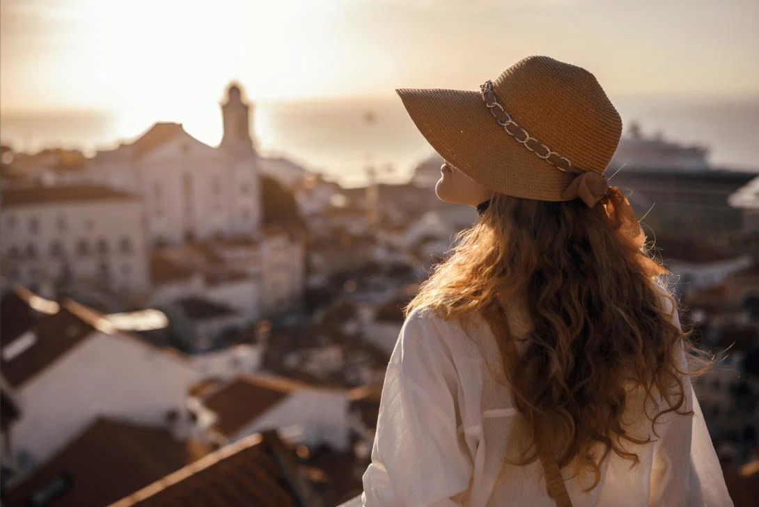 A woman enjoys a view across a city