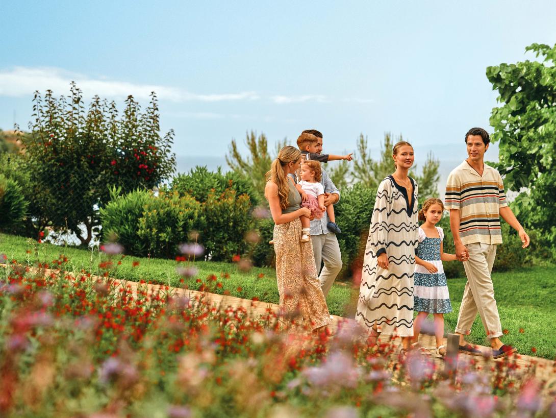 (credit: Mar-Bella Collection) Two families walking on a path with flowers either side