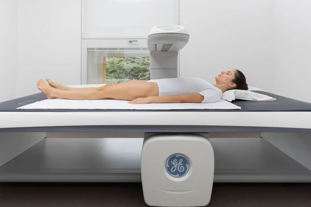 Woman lying down for DEXA scan