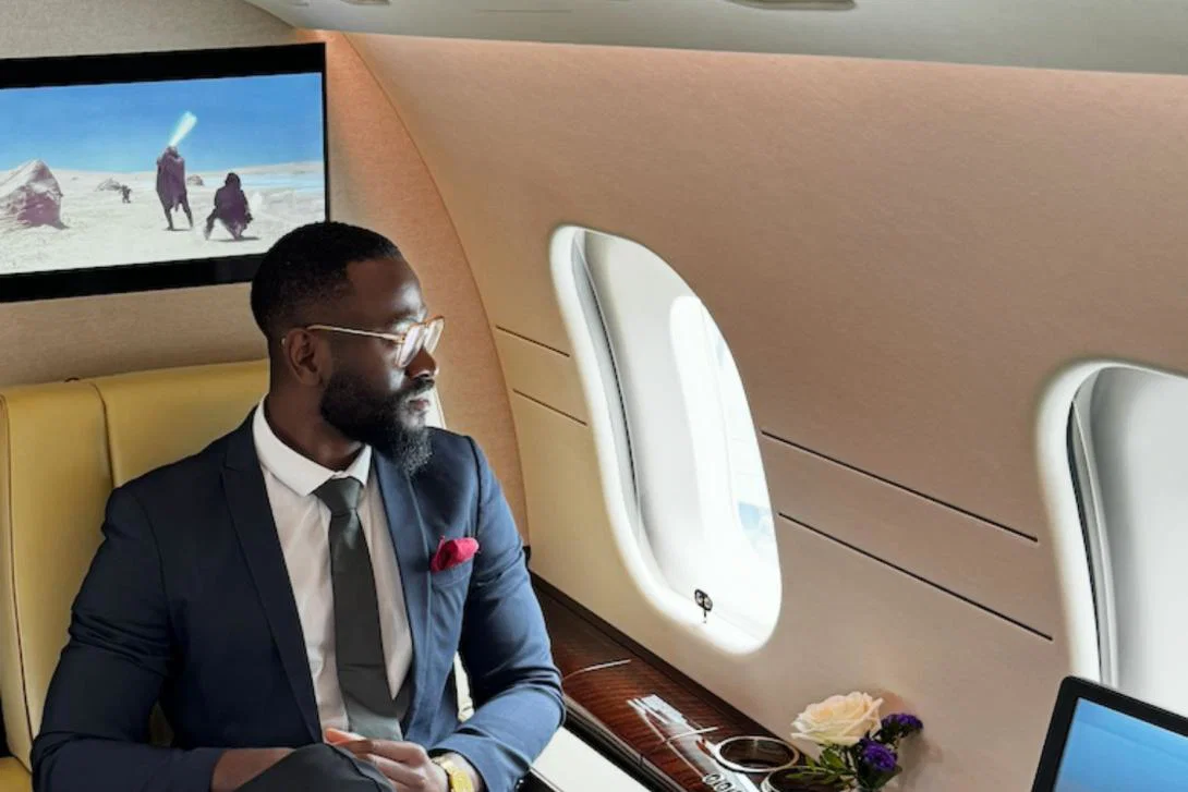Man looking out window on private jet