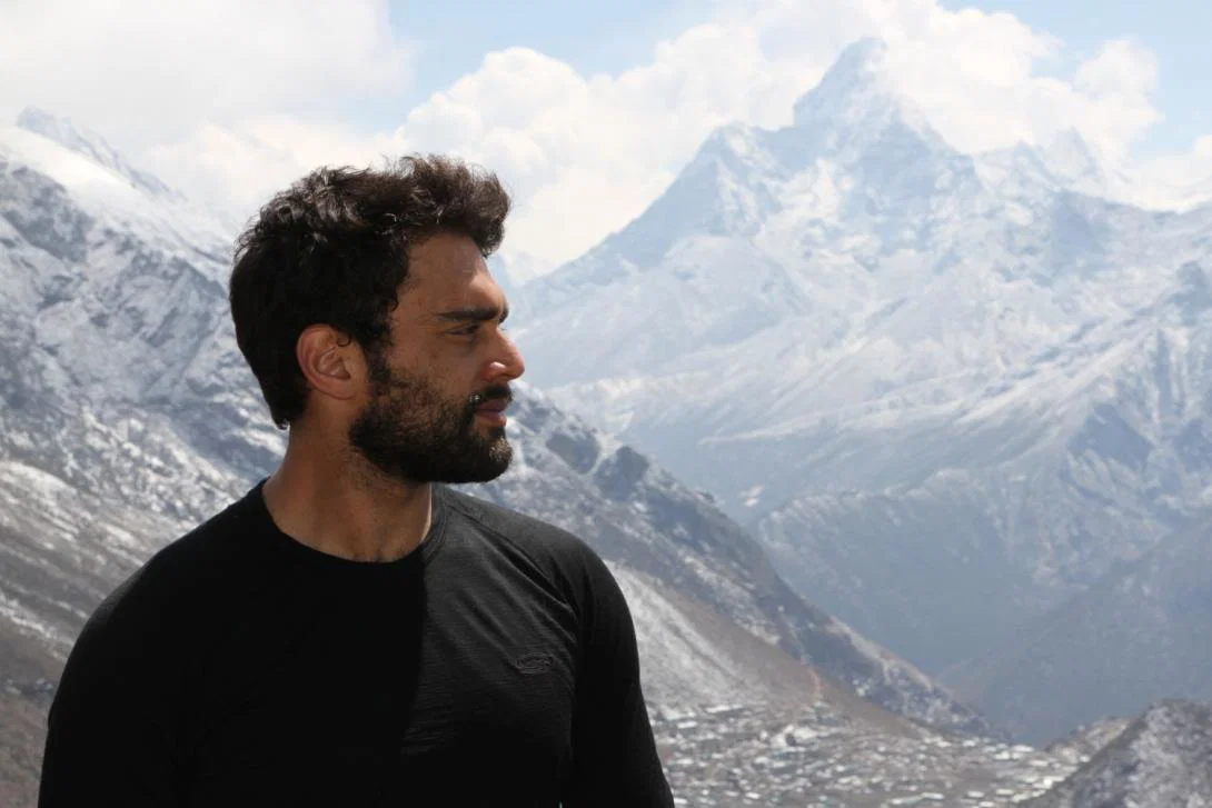 Man in black shirt looking at mountains