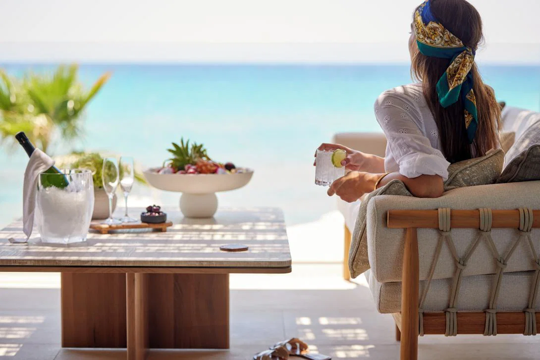 A woman relaxing on a balcony at Sani Asterias